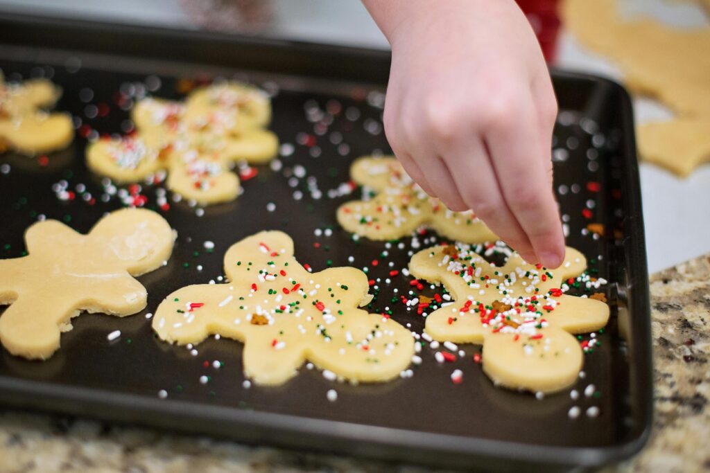 Rolling out gluten-free Christmas cookie dough between parchment paper