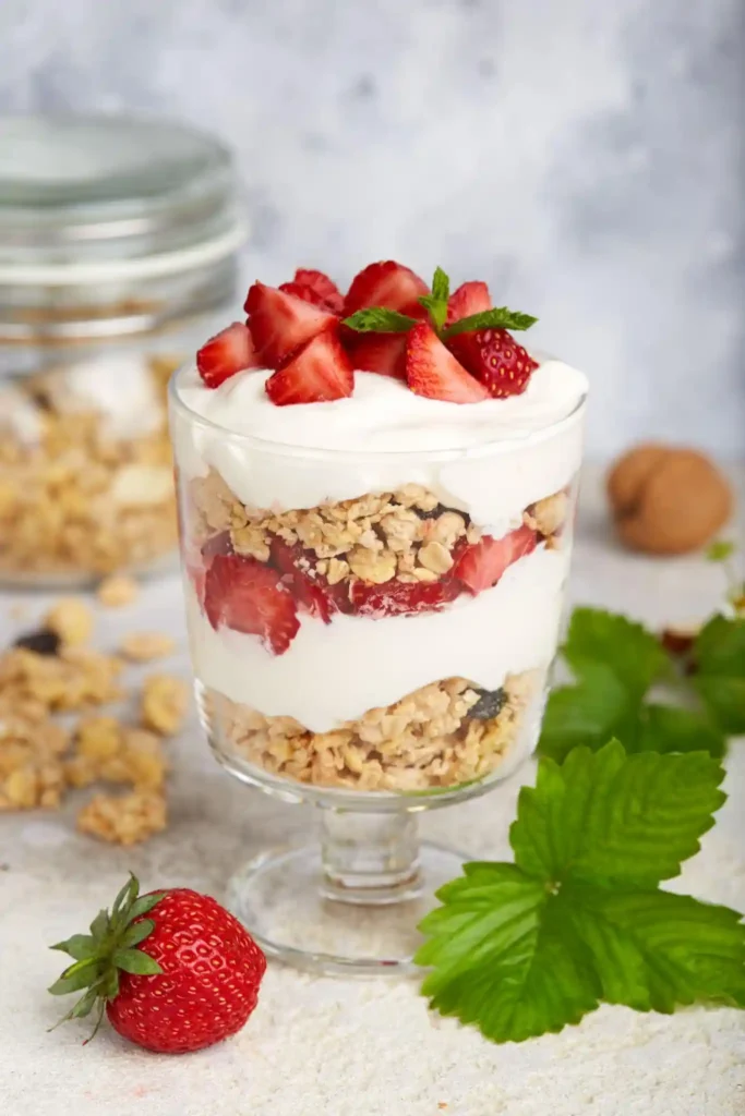 Easy Strawberry Dessert Recipes 3 A tall glass strawberry yogurt parfait with granola and honey — a healthy and light strawberry dessert recipe